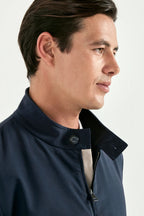 Man wearing a navy blue jacket on a white background