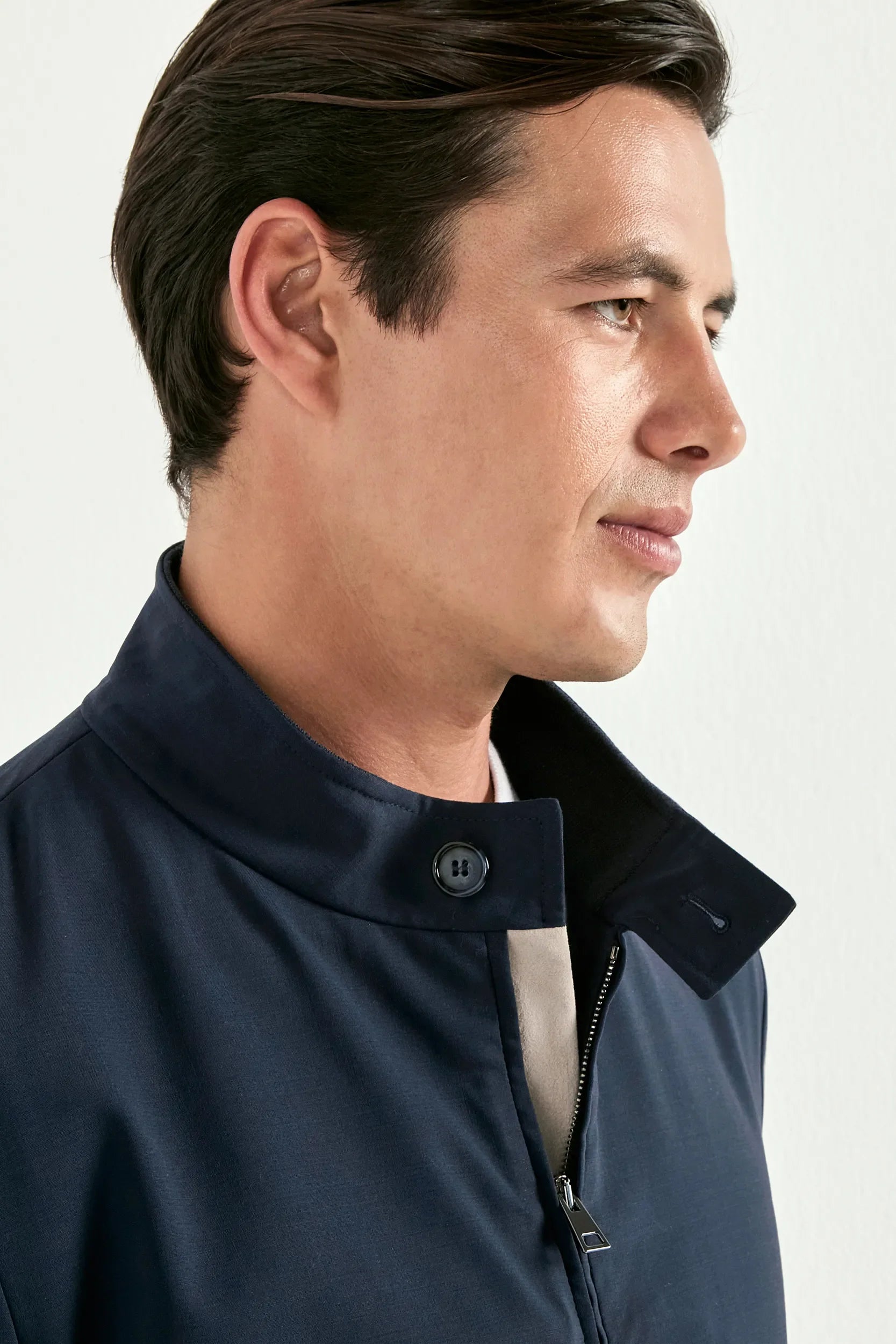 Man wearing a navy blue jacket on a white background