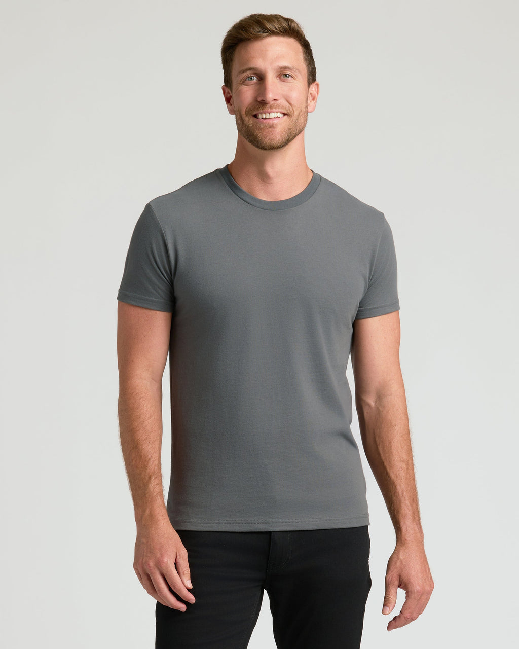 Man wearing the Staple Classic Crew Neck T-shirt, fitted and gray.